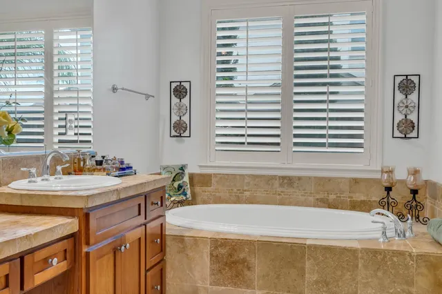 a kitchen with stainless steel appliances granite countertop a sink a stove and a wooden cabinets