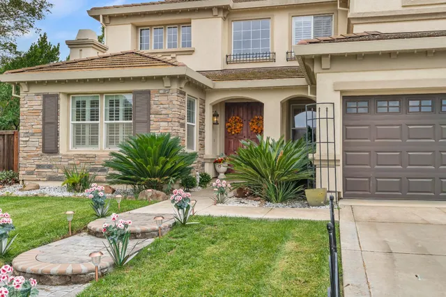 a living room with furniture a chandelier and a rug