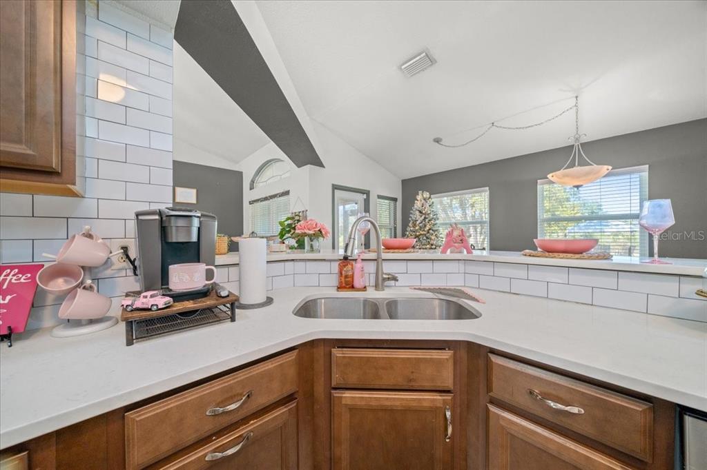 5365 Southwest 111th Lane Road Ocala, FL 34476 - Photo 11 of 42 a kitchen with kitchen island white cabinets and counter space