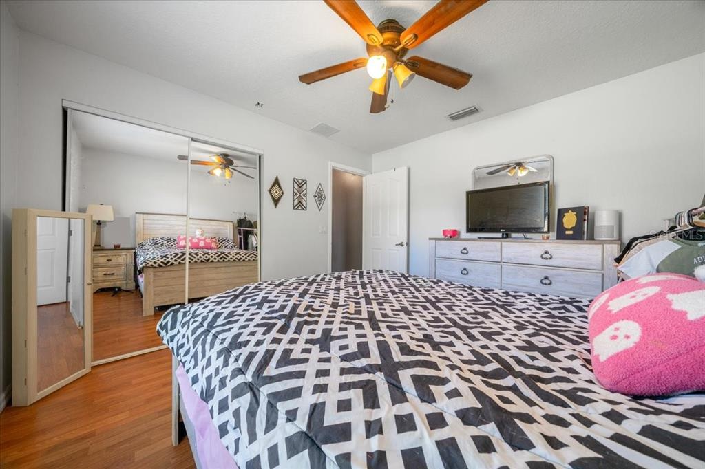 5365 Southwest 111th Lane Road Ocala, FL 34476 - Photo 34 of 42 a bedroom with a bed and a flat screen tv