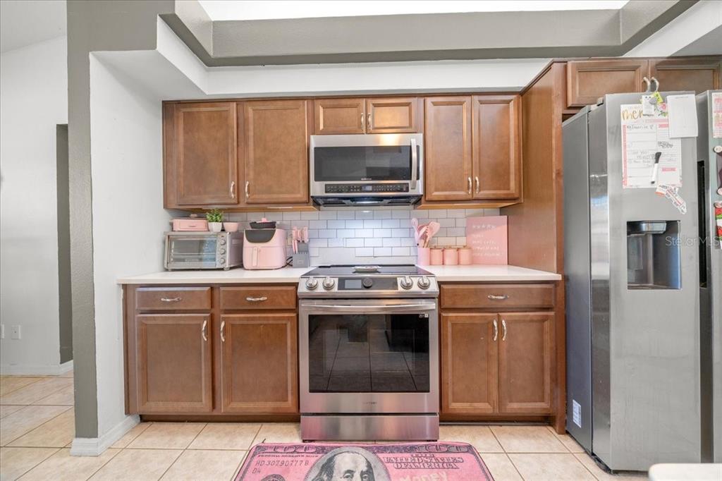 5365 Southwest 111th Lane Road Ocala, FL 34476 - Photo 9 of 42 a kitchen with stainless steel appliances granite countertop a stove a sink and a refrigerator