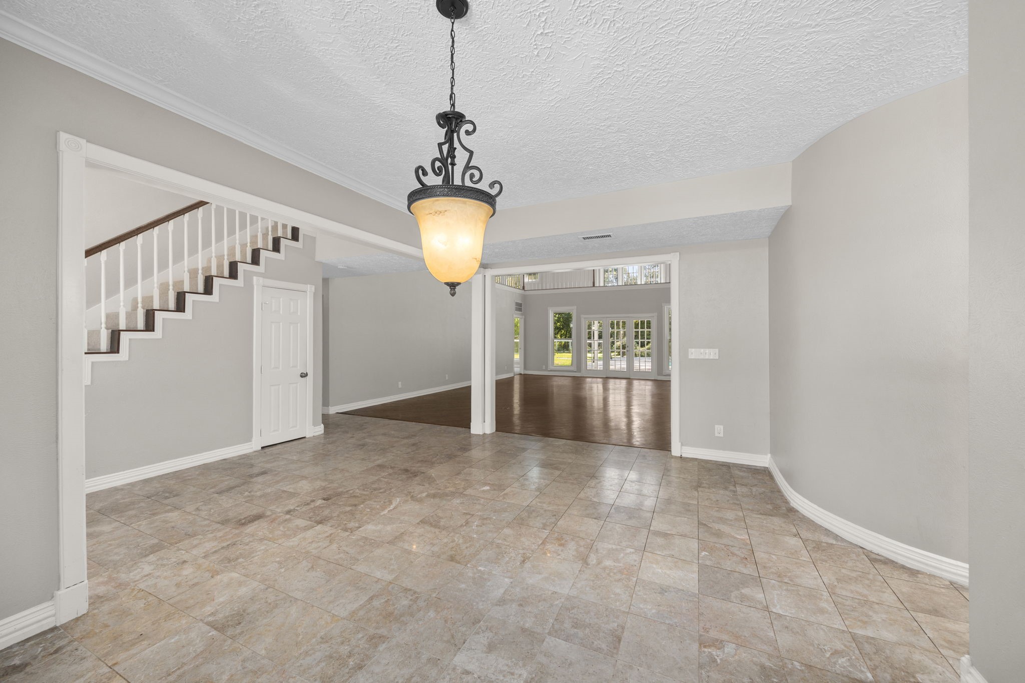 21802 Lindheimer Road Hockley, TX 77447 - Photo 21 of 50 a view of a hallway with a chandelier and stairs