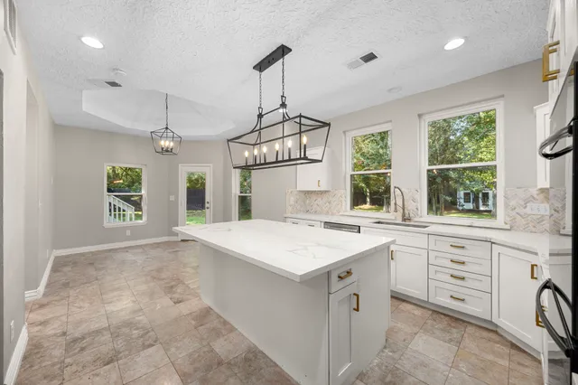 a kitchen with a sink stove and refrigerator