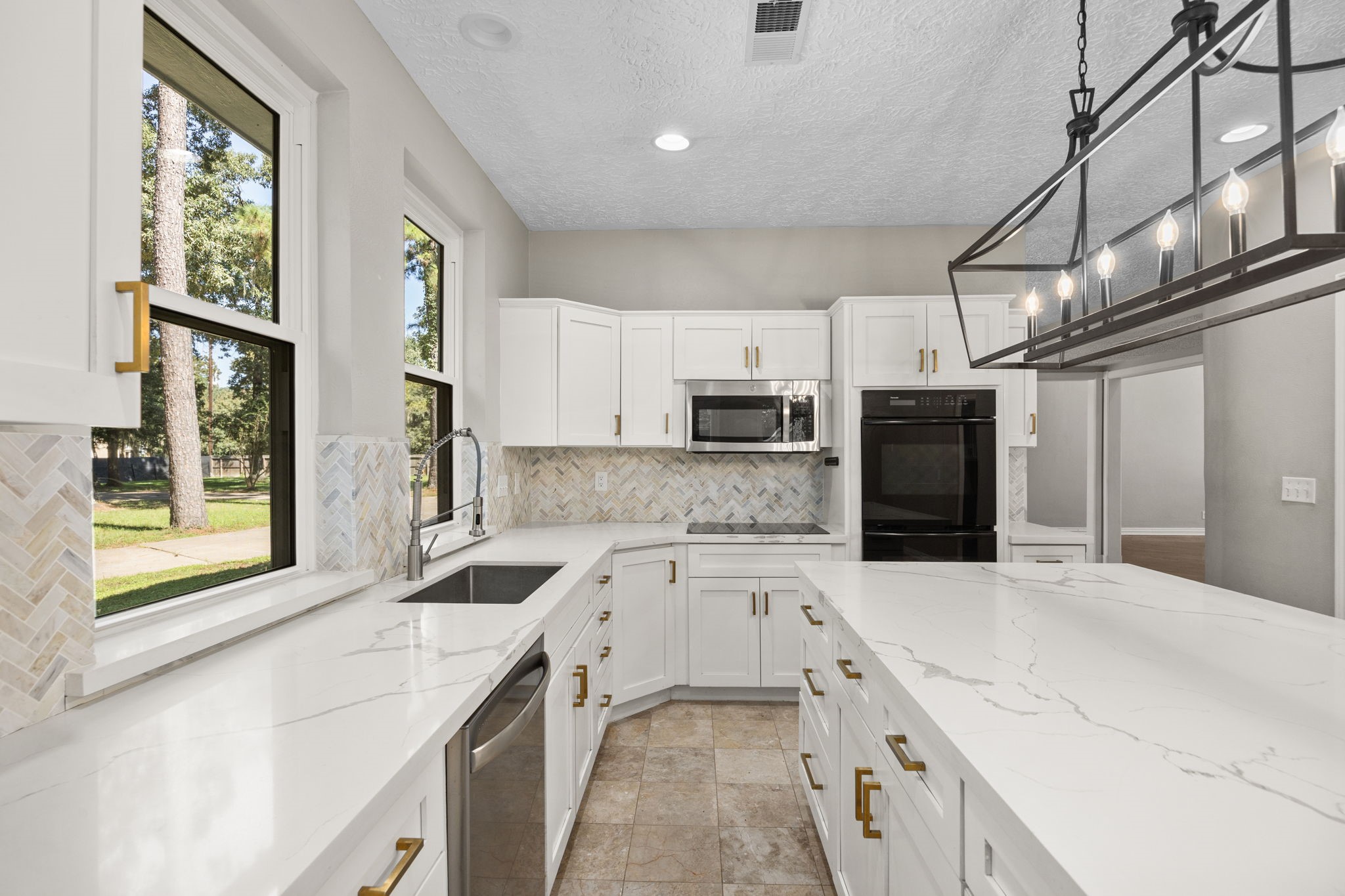 21802 Lindheimer Road Hockley, TX 77447 - Photo 24 of 50 a view of a kitchen with stainless steel appliances granite countertop a sink and a stove top oven