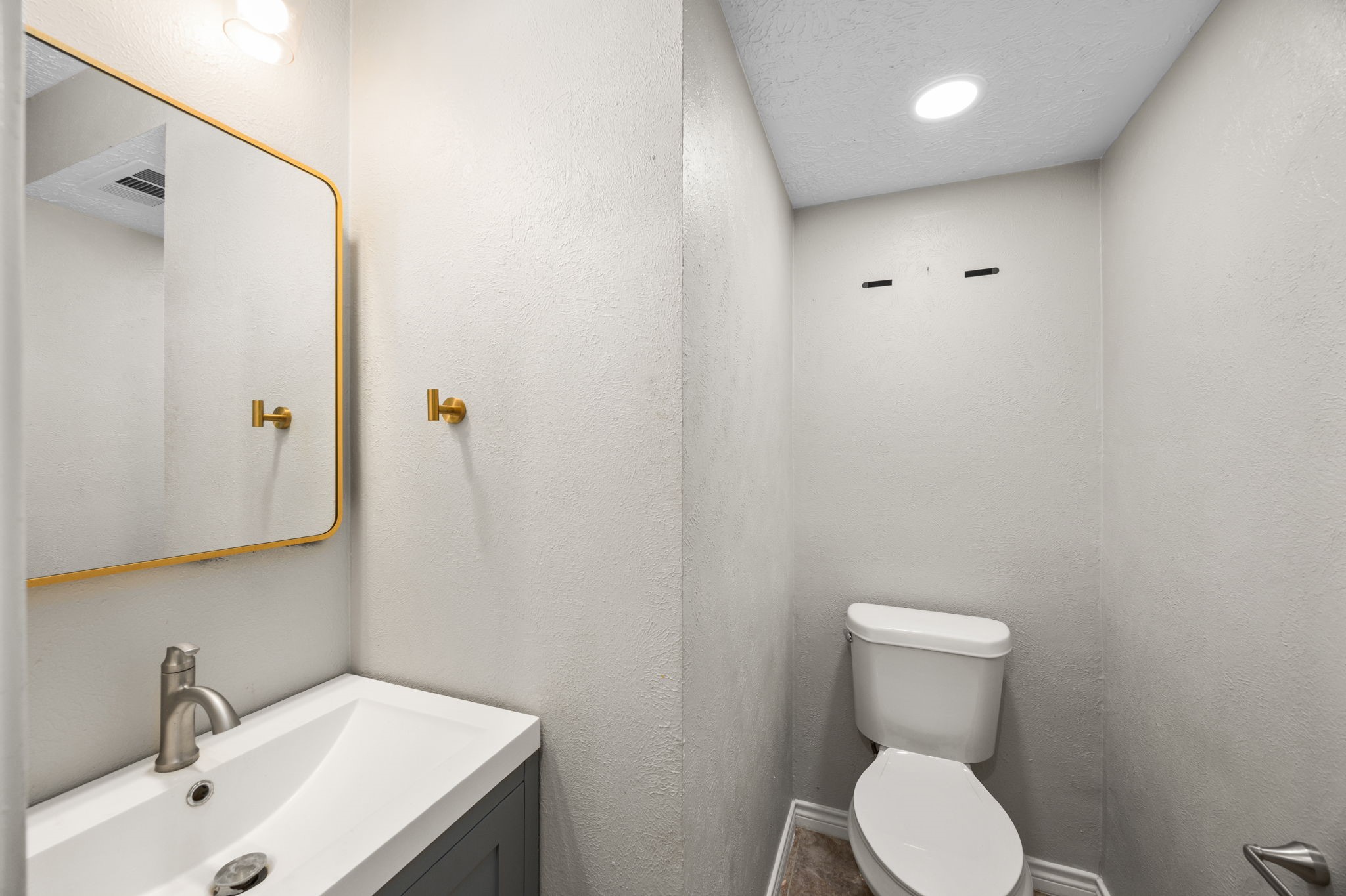 21802 Lindheimer Road Hockley, TX 77447 - Photo 26 of 50 a bathroom with a toilet a sink and mirror