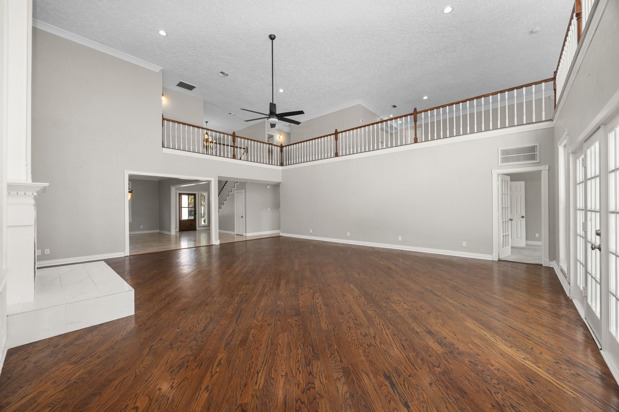 21802 Lindheimer Road Hockley, TX 77447 - Photo 29 of 50 a view of a room with wooden floor staircase and a kitchen