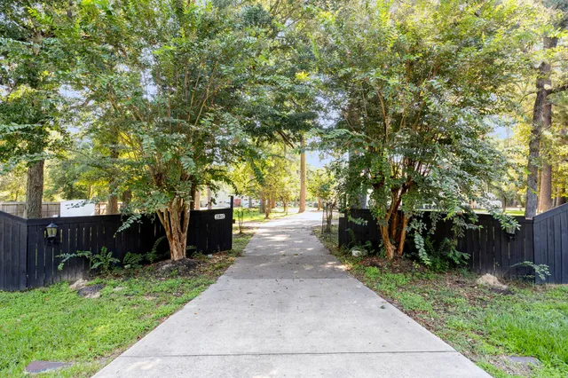 a front view of a house with a yard and tree