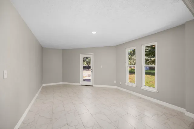 a view of a livingroom with a ceiling fan and window