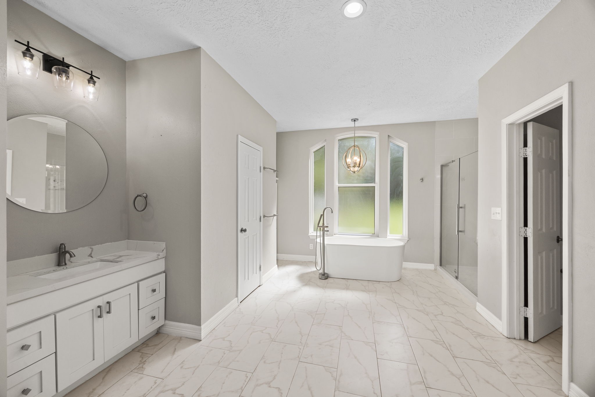 21802 Lindheimer Road Hockley, TX 77447 - Photo 36 of 50 a spacious bathroom with a tub sink and mirror