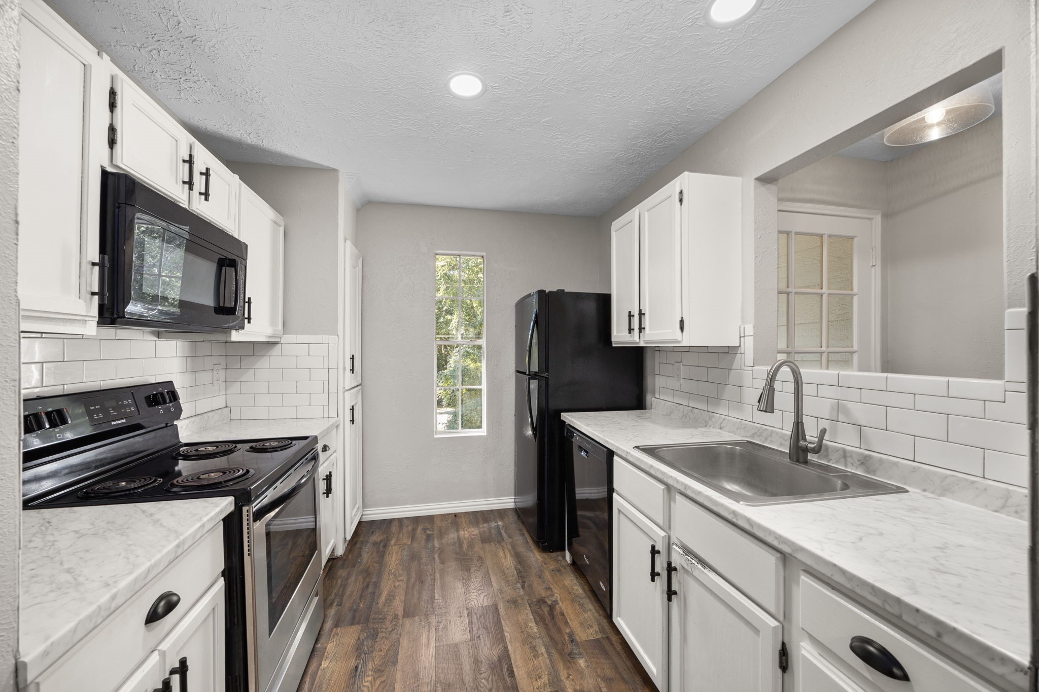 21802 Lindheimer Road Hockley, TX 77447 - Photo 48 of 50 a kitchen with stainless steel appliances granite countertop a sink stove microwave and refrigerator