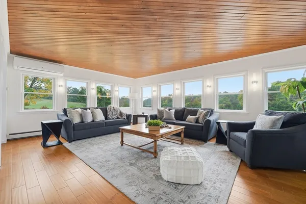 a living room with furniture rug and a table