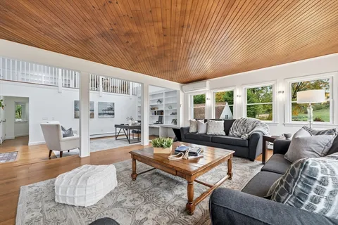 a bedroom with a bed a couch and a window