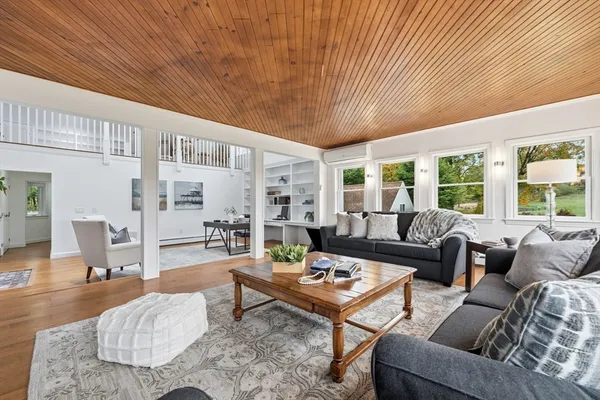 a bedroom with a bed a couch and a window