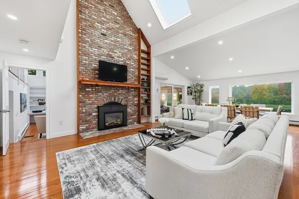 a living room with furniture a fireplace and a flat screen tv