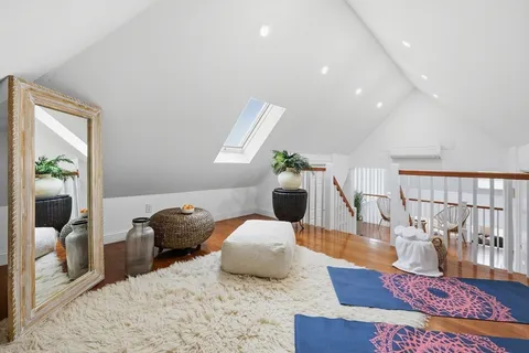 a bathroom with a toilet and a window