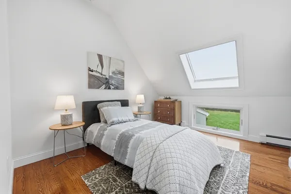 a bedroom with a bed and a lamp
