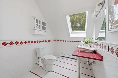 a bathroom with a shower sink and mirror
