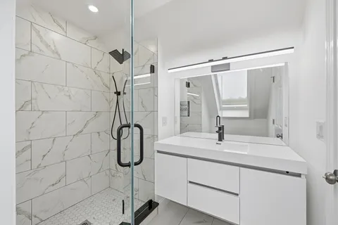 a living room with furniture kitchen view and a chandelier