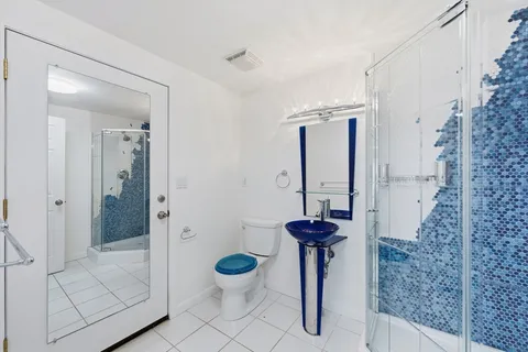 a kitchen with granite countertop a refrigerator and a sink