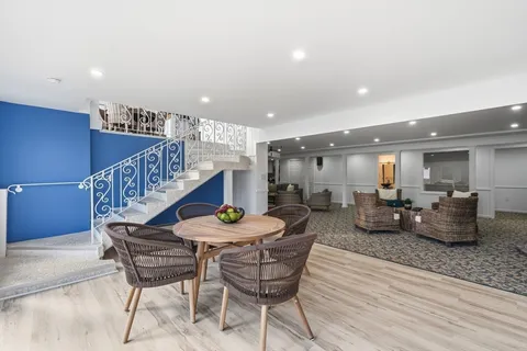 a view of dining room with furniture and wooden floor