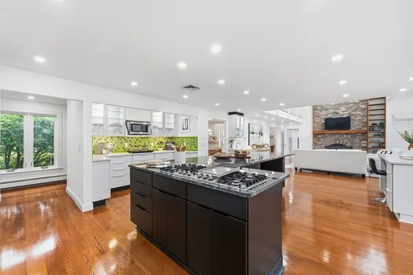 a kitchen with stainless steel appliances granite countertop a stove top oven a sink counter space and cabinets