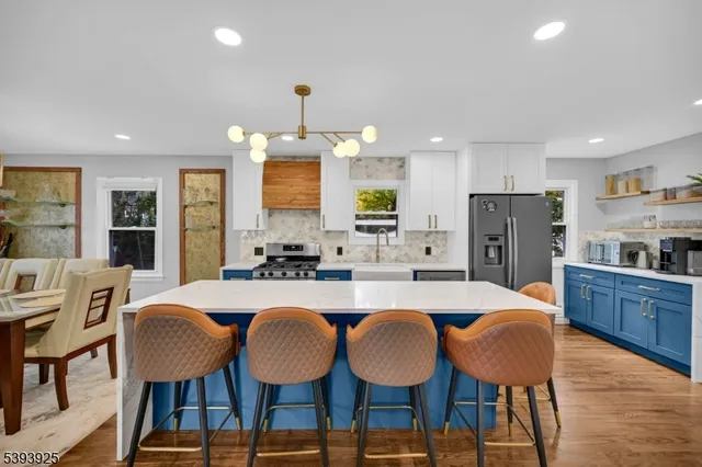 a large kitchen with dining table and chairs
