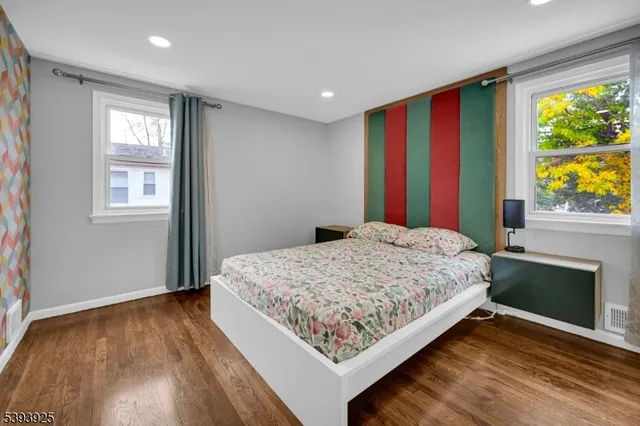 a spacious bathroom with a double vanity sink a mirror and a bathtub