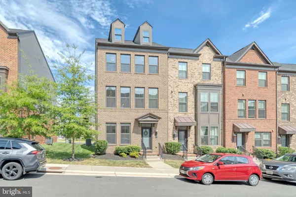 a front view of a residential apartment building with a yard