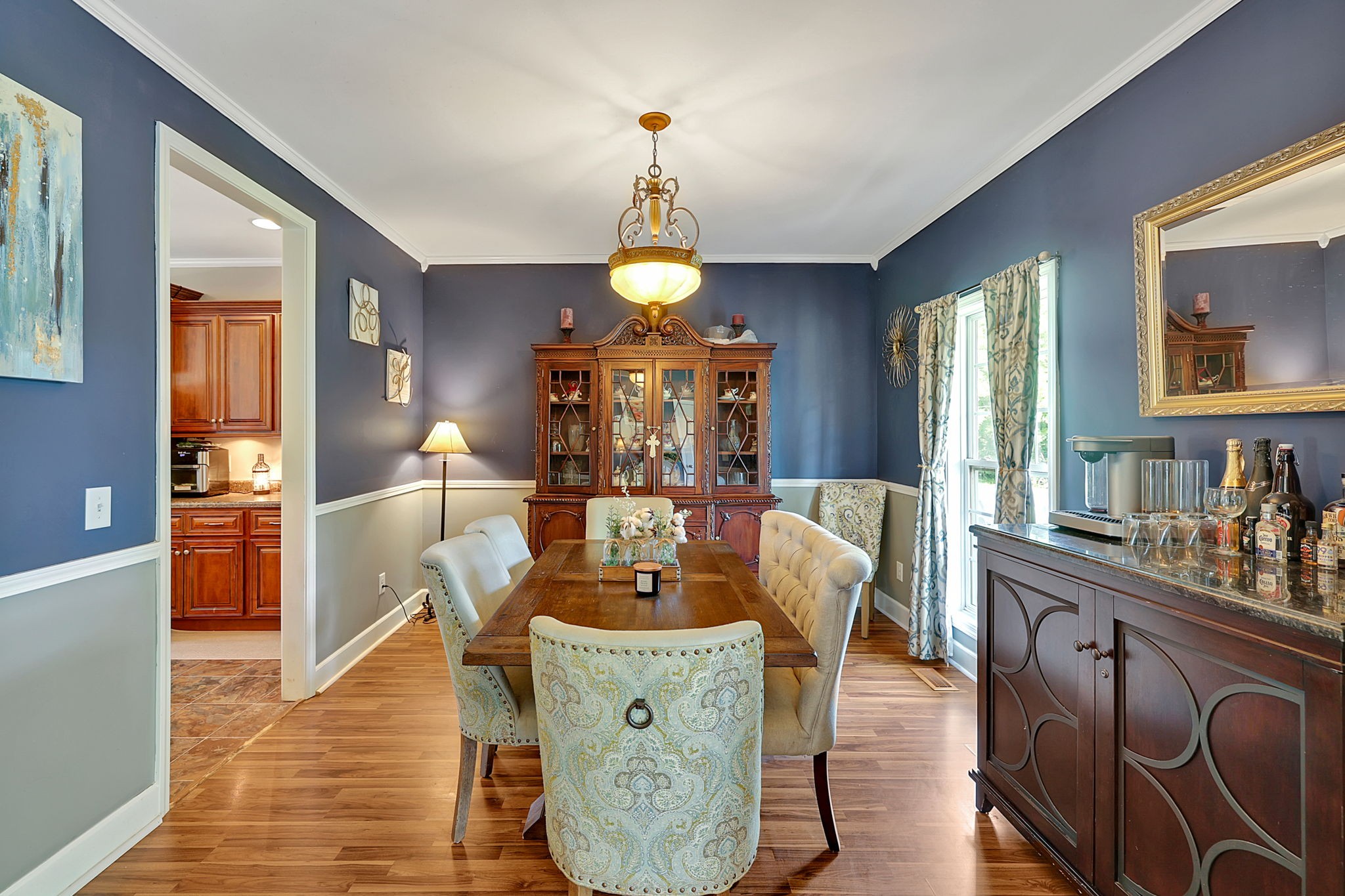 3079 Cairo Bend Road Lebanon, TN 37087 - Photo 16 of 67 a dining room with wooden floor a chandelier a wooden table and chairs