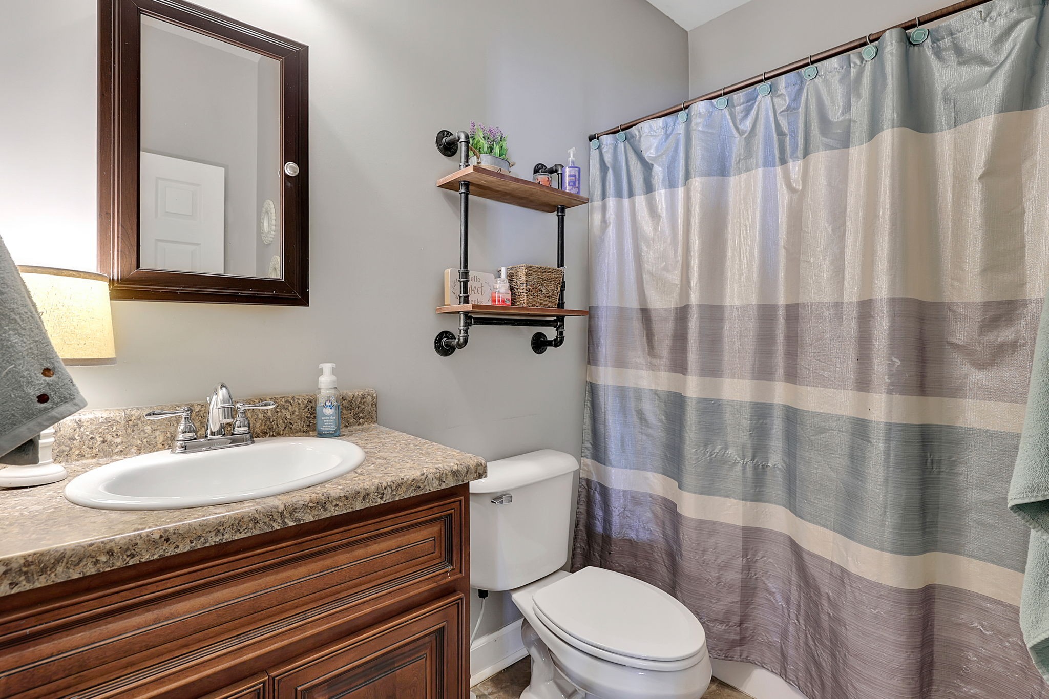 3079 Cairo Bend Road Lebanon, TN 37087 - Photo 42 of 67 a bathroom with a granite countertop sink mirror vanity and toilet