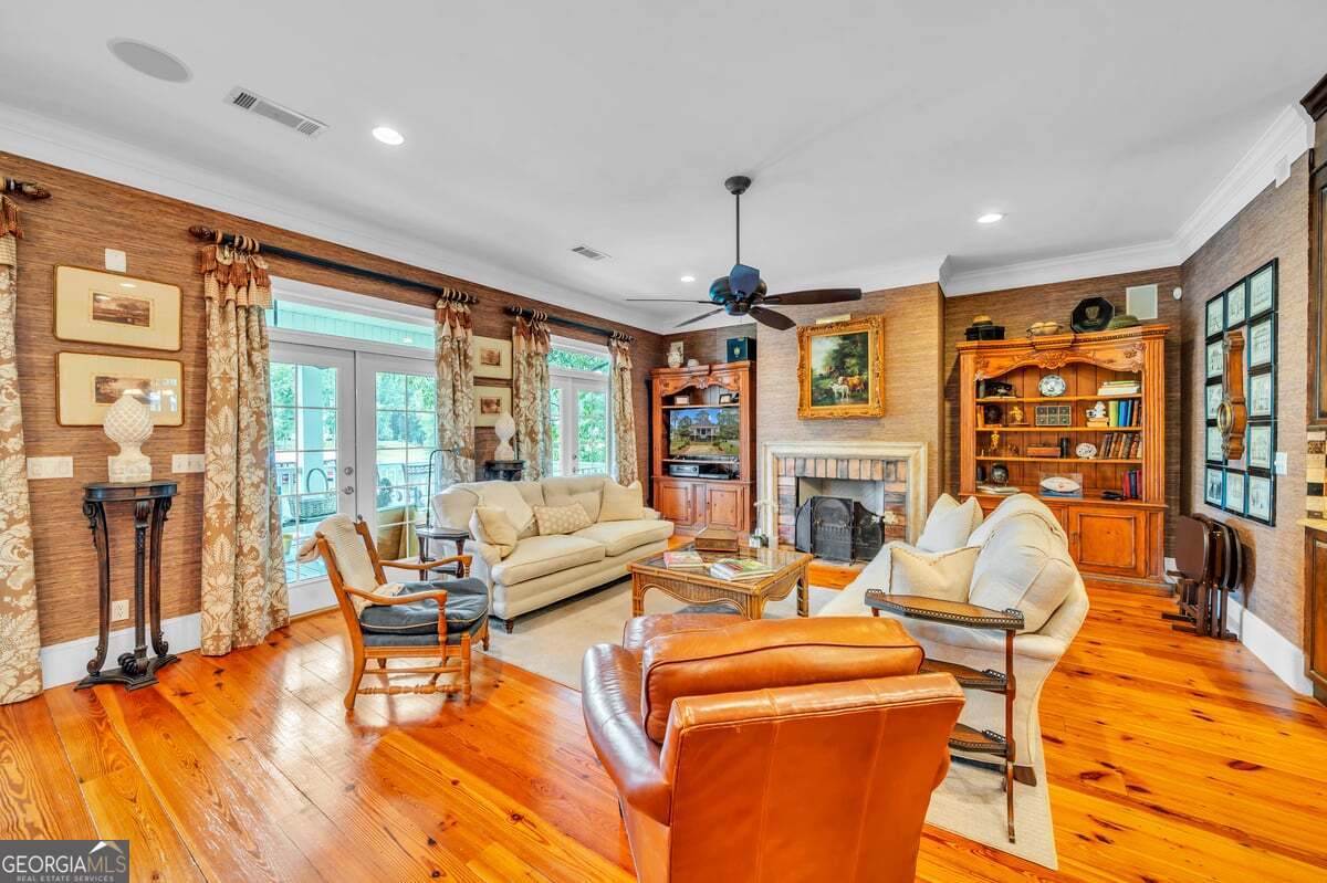 696 Cork Ferry Road Cordele, GA 31015 - Photo 13 of 79 a living room with fireplace furniture and a floor to ceiling window