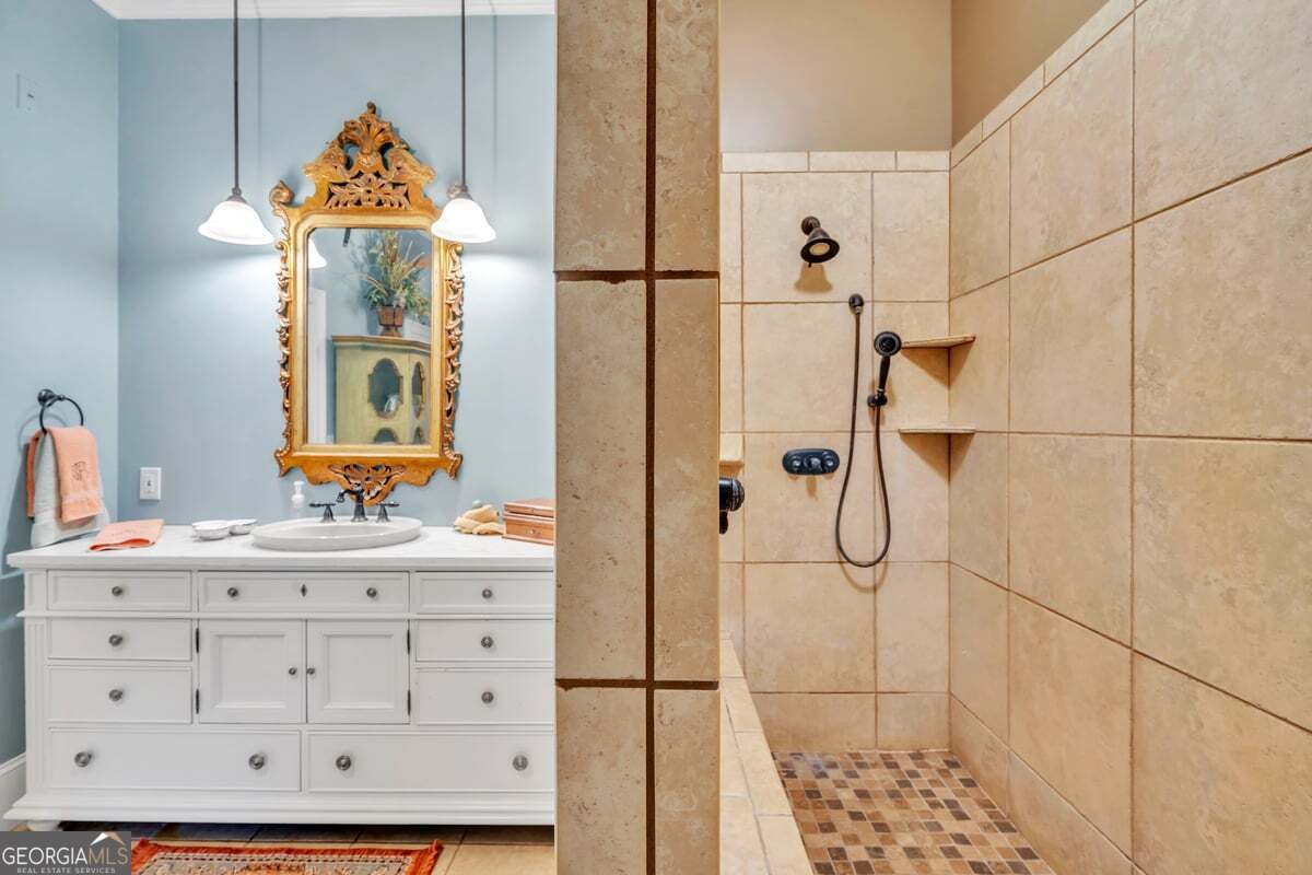 696 Cork Ferry Road Cordele, GA 31015 - Photo 26 of 79 a bathroom with a sink a mirror and a shower