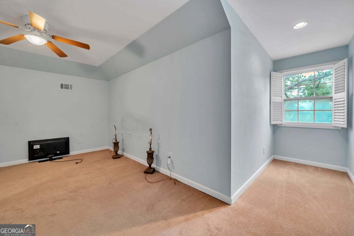 696 Cork Ferry Road Cordele, GA 31015 - Photo 39 of 79 an empty room with windows and fan