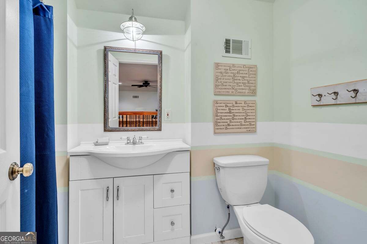 696 Cork Ferry Road Cordele, GA 31015 - Photo 40 of 79 a bathroom with a toilet a sink and mirror