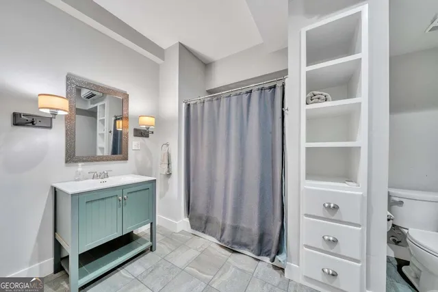 an aerial view of a houses with outdoor space and trees all around