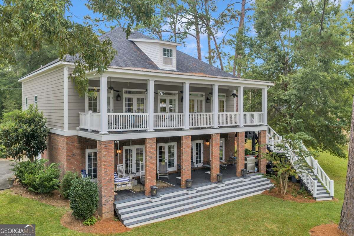 696 Cork Ferry Road Cordele, GA 31015 - Photo 54 of 79 a front view of a house with a yard table and chairs