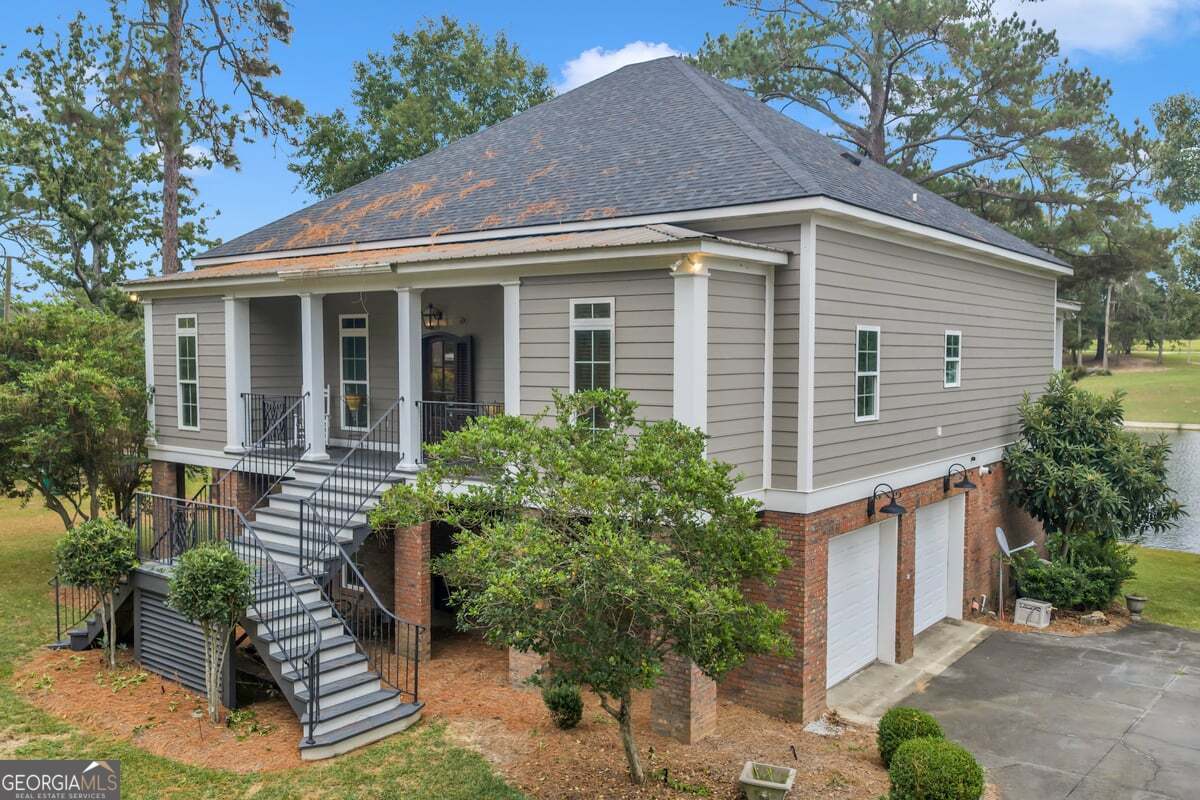 696 Cork Ferry Road Cordele, GA 31015 - Photo 6 of 79 a view of a house with brick walls and potted plants