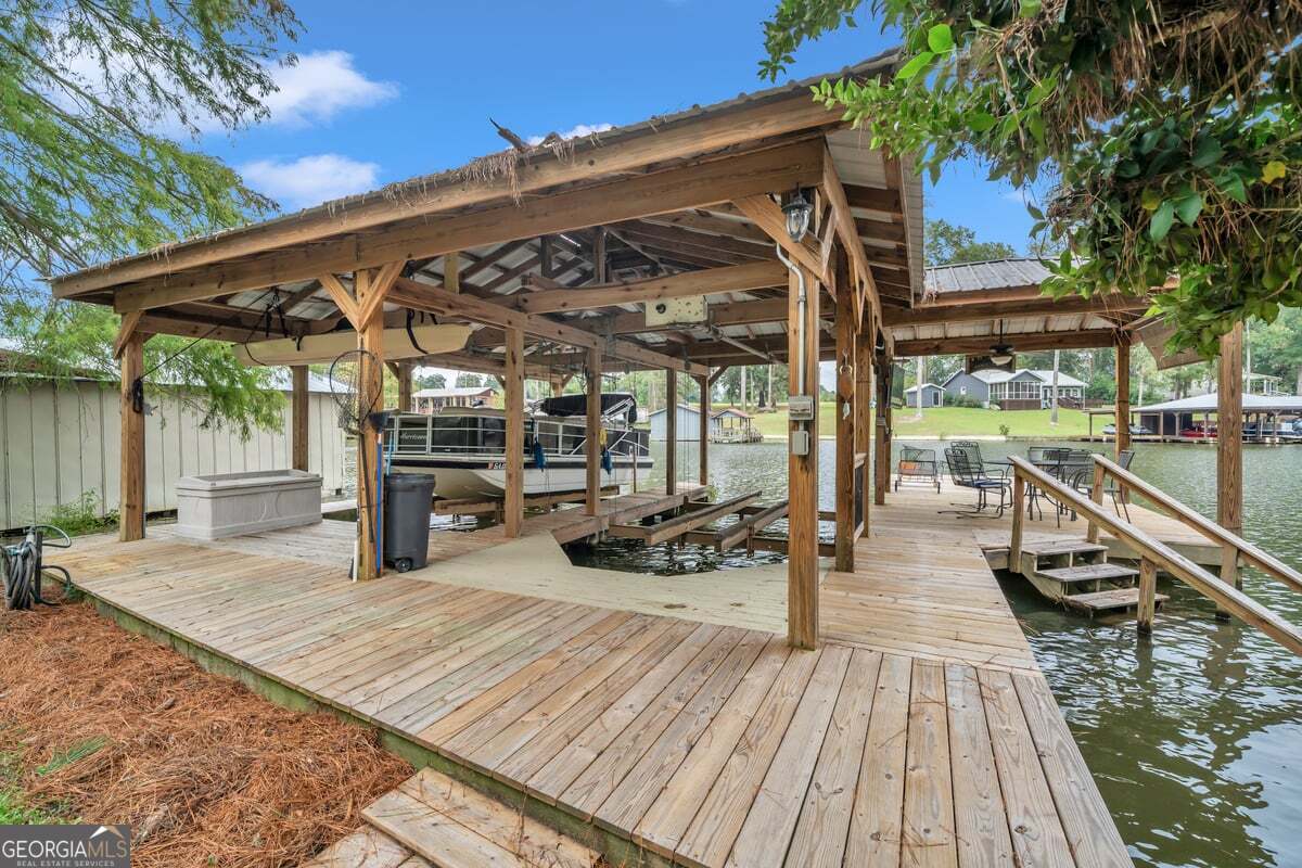 696 Cork Ferry Road Cordele, GA 31015 - Photo 63 of 79 a view of a patio with table and chairs wooden floor and fence