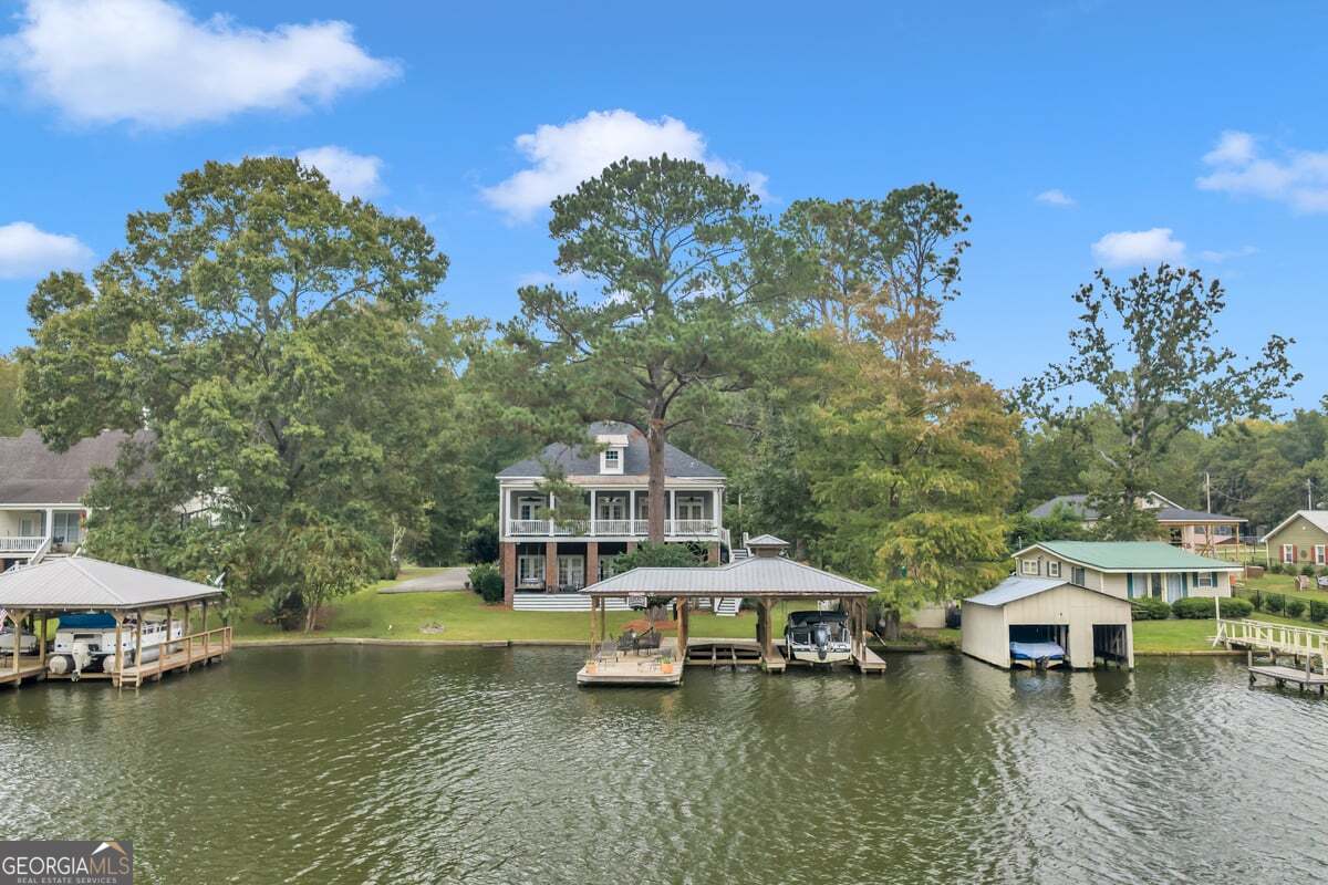 696 Cork Ferry Road Cordele, GA 31015 - Photo 70 of 79 a view of a lake with a house swimming pool and outdoor seating