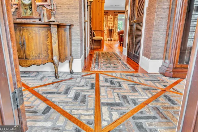 a living room with fireplace furniture and a floor to ceiling window