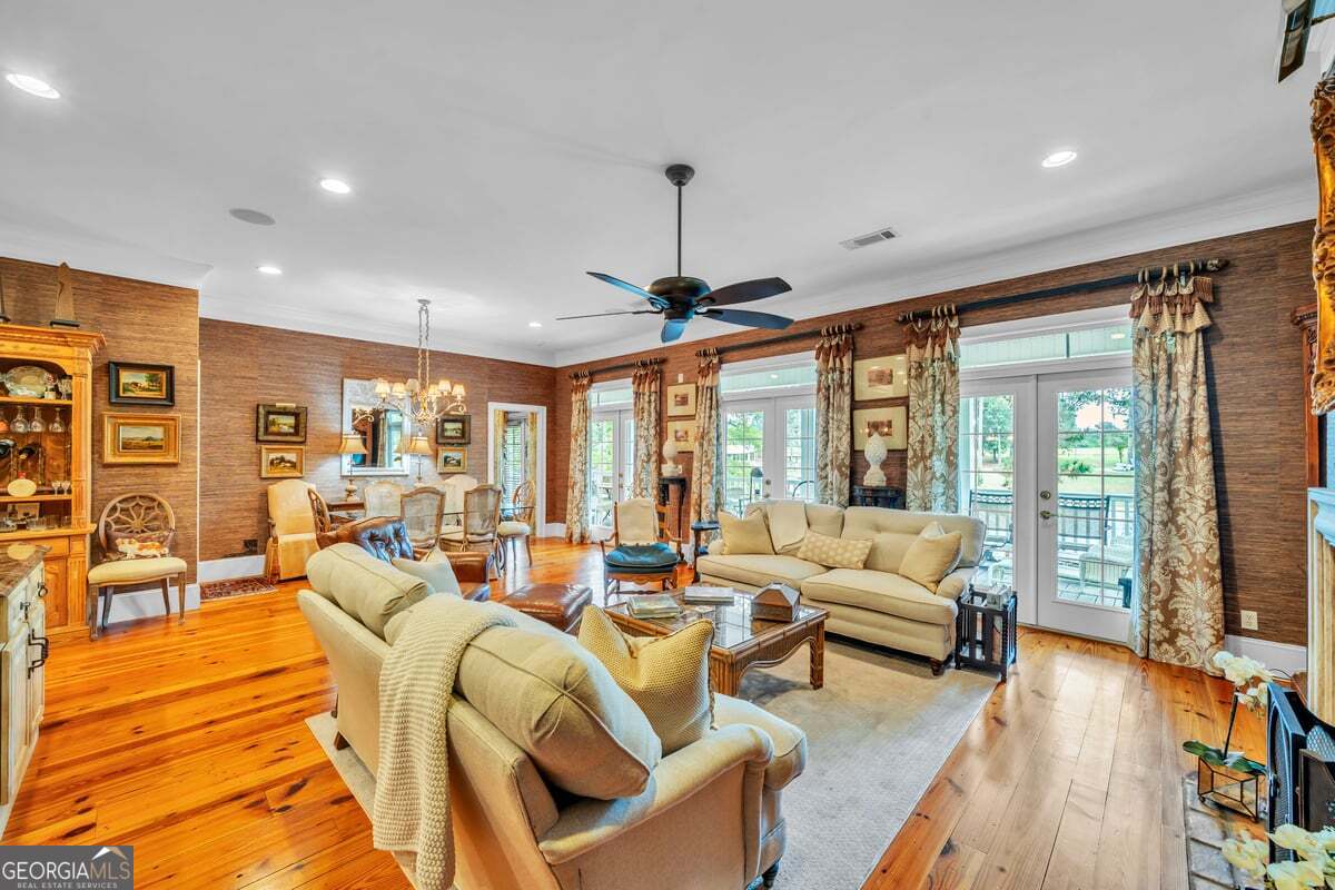 696 Cork Ferry Road Cordele, GA 31015 - Photo 10 of 79 a living room with furniture and floor to ceiling windows