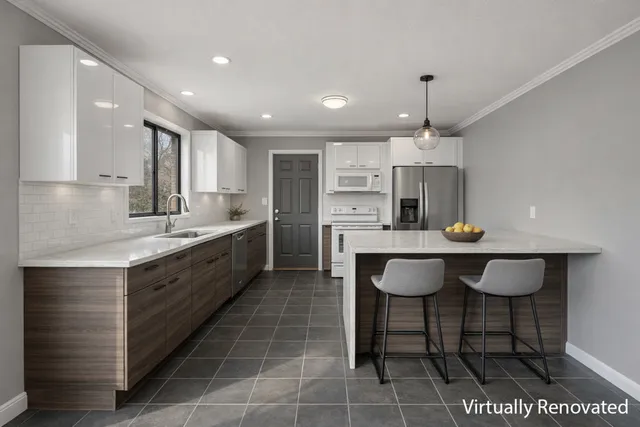 a large kitchen with kitchen island granite countertop a table chairs sink and cabinets