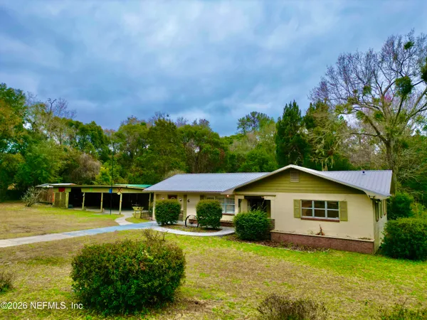 a front view of a house with large windows