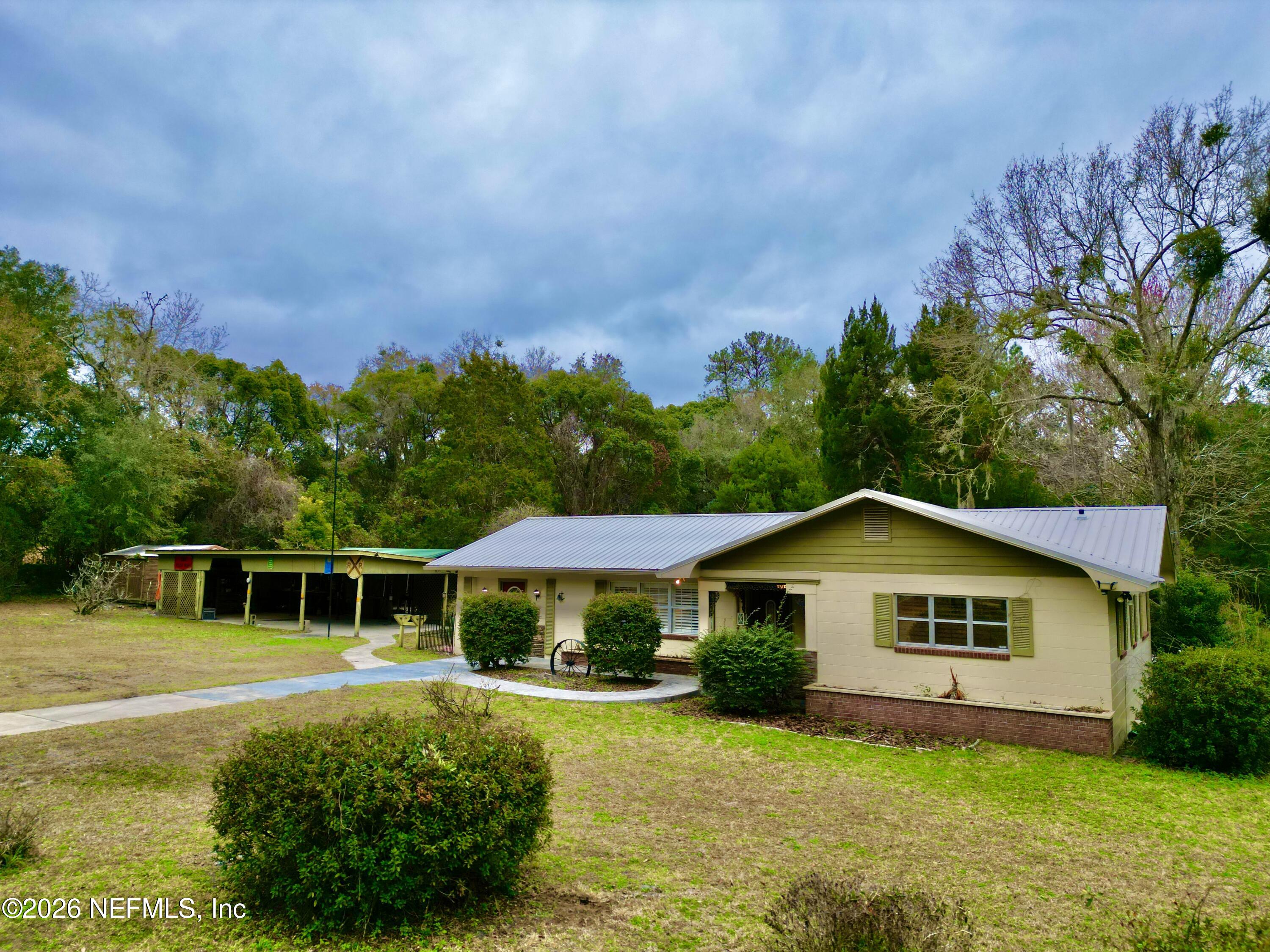 17221 Northeast 77th Lane Hawthorne, FL 32640 - Photo 11 of 59 a house with green field in front of it