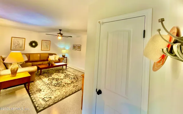 a view of a dining room with furniture and a chandelier