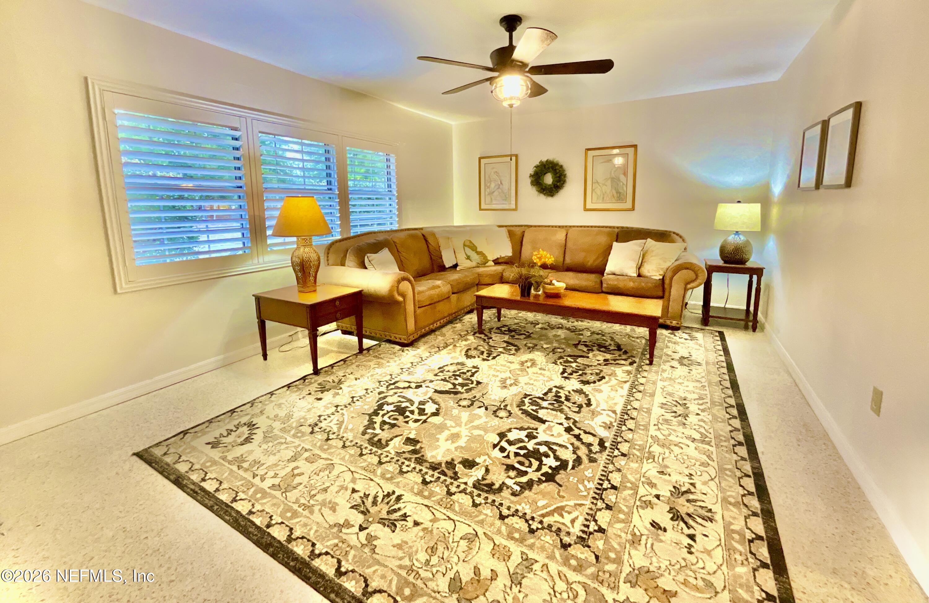17221 Northeast 77th Lane Hawthorne, FL 32640 - Photo 19 of 59 a living room with a couch and dresser next to a window