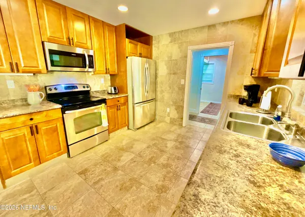 a kitchen with stainless steel appliances granite countertop a sink and a cabinets