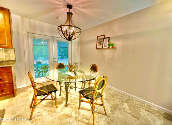 a view of a dining room with furniture and chandelier