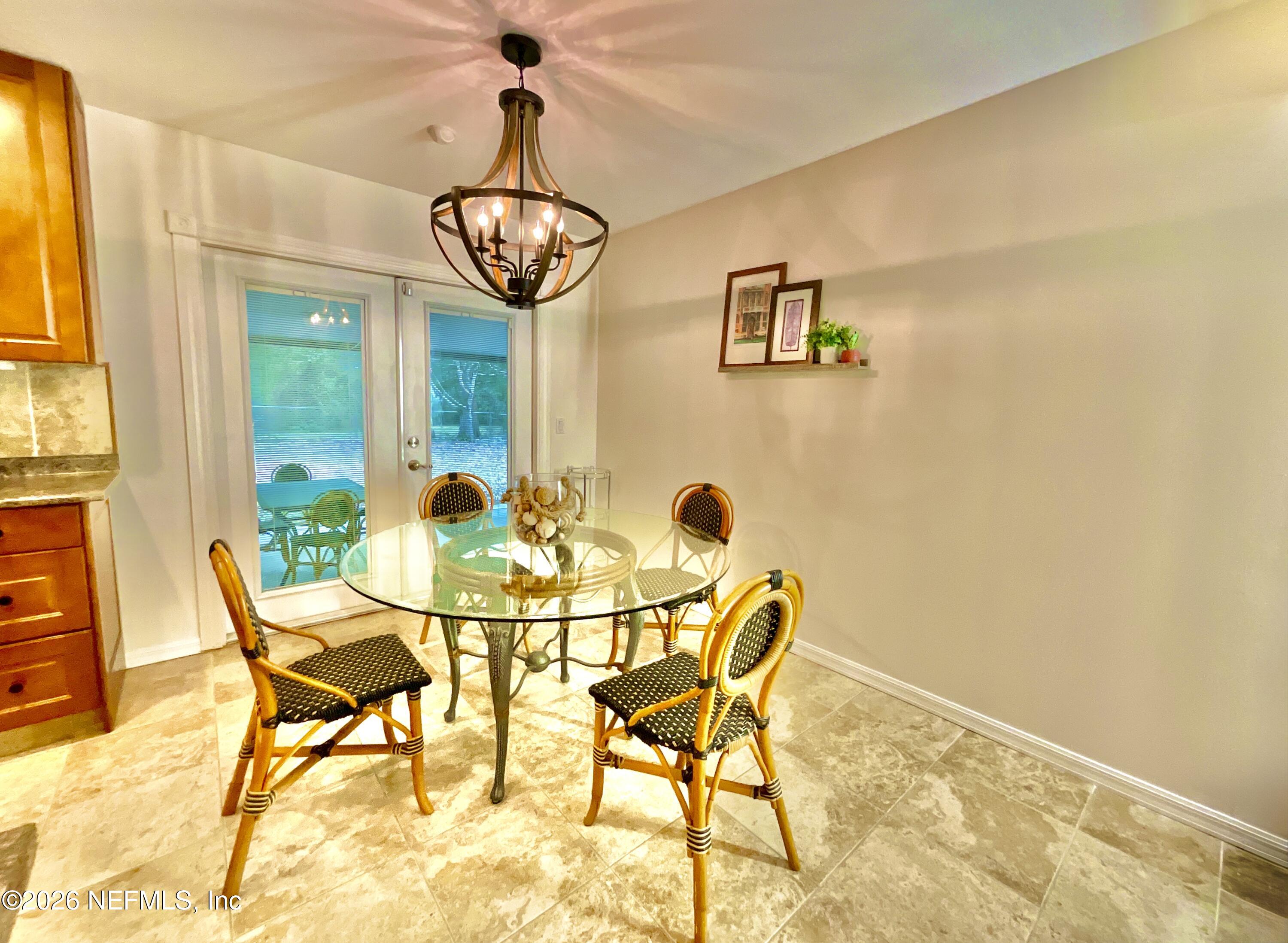 17221 Northeast 77th Lane Hawthorne, FL 32640 - Photo 21 of 59 a view of a dining room with furniture and a chandelier