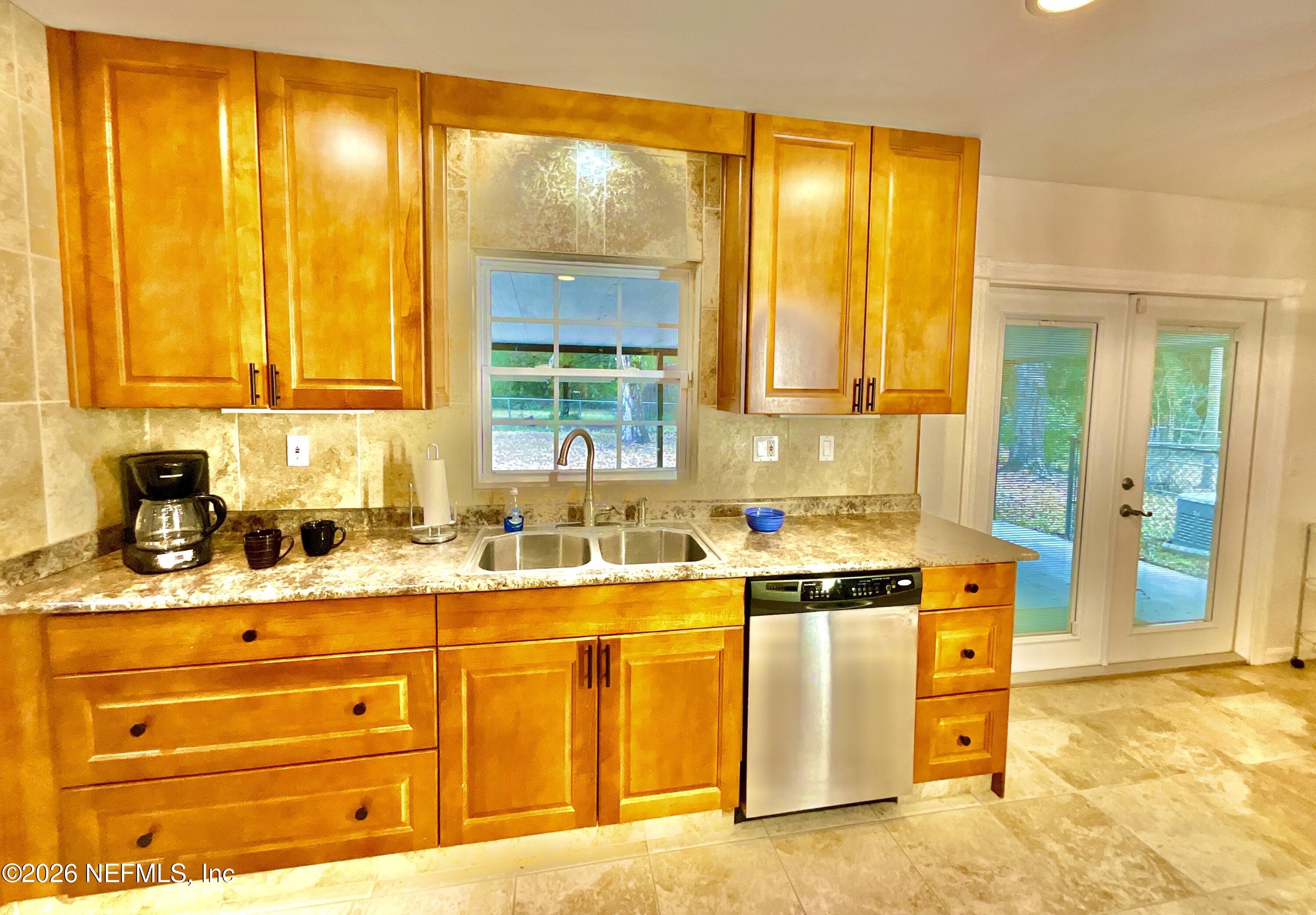 17221 Northeast 77th Lane Hawthorne, FL 32640 - Photo 23 of 59 a kitchen with stainless steel appliances granite countertop a sink and a cabinets
